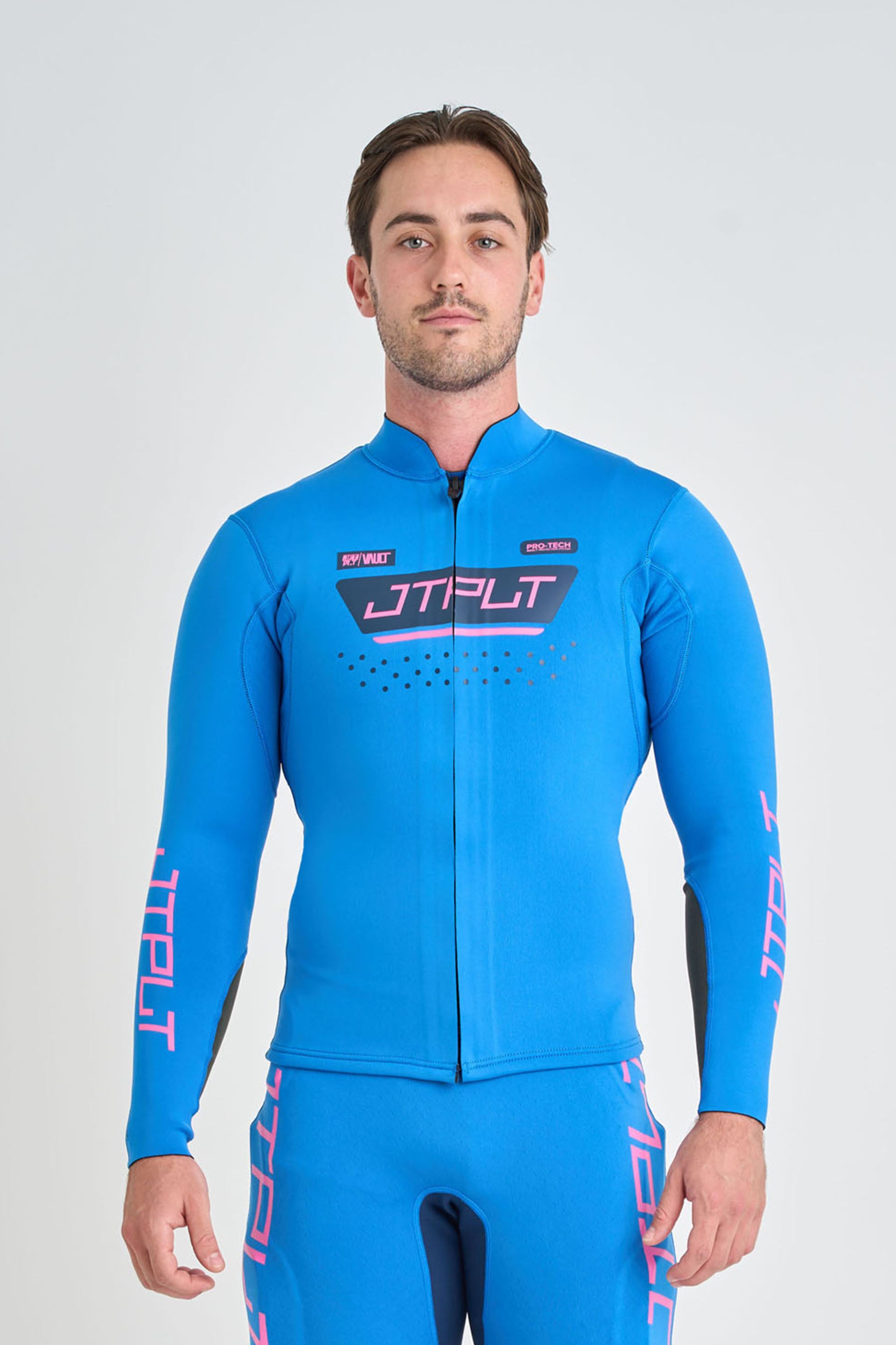 Man wearing a blue neoprene jacket 'JTPLT' branding on a white background