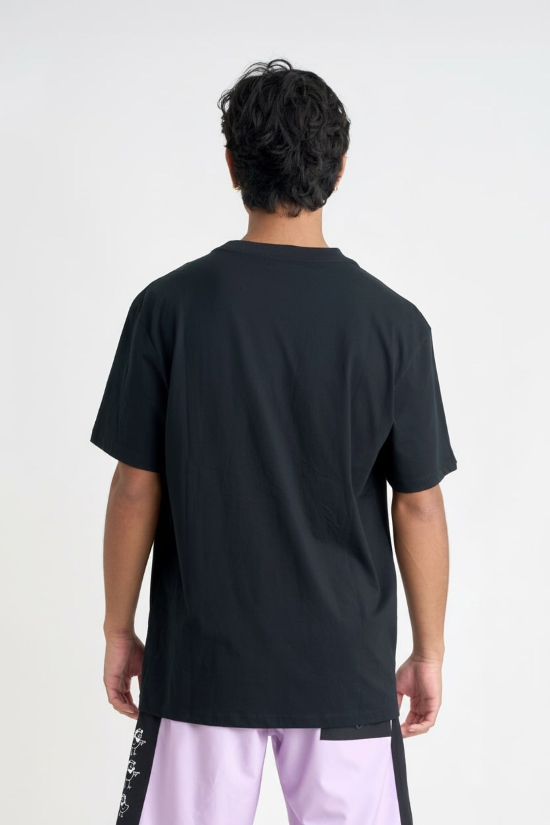 Person wearing a black t-shirt on a white background — view 27 (3)