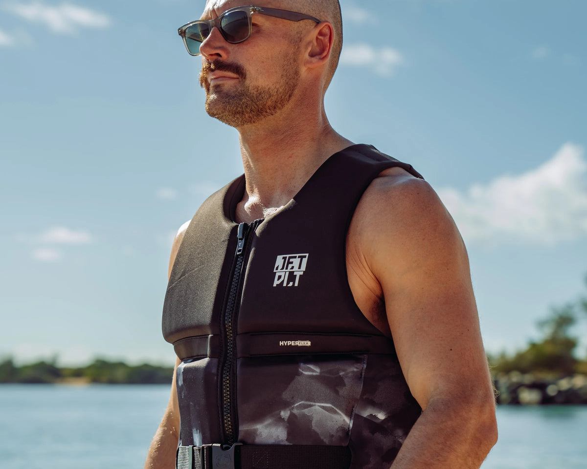 Rider wearing the Jetpilot 360 Life Jacket in Black by the water